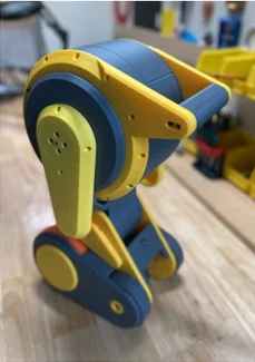 Rokx from the side, showing the yellow arm and a drive wheel